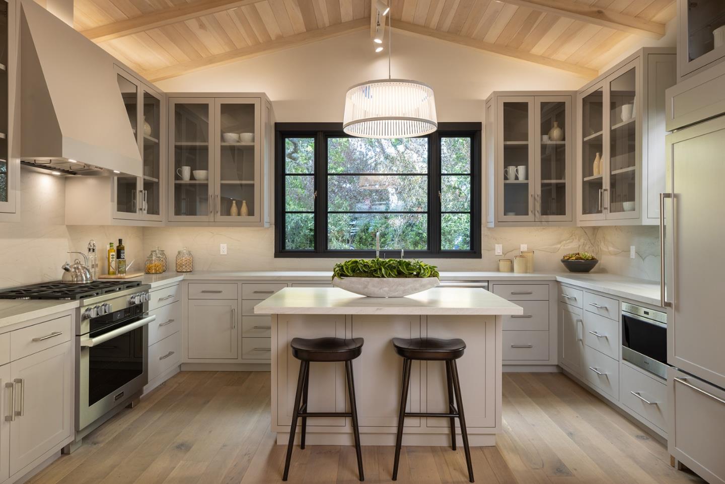 25962 Ridgewood Road Carmel, CA 93923 - Photo 8 of 21 a kitchen with a stove a sink and cabinets