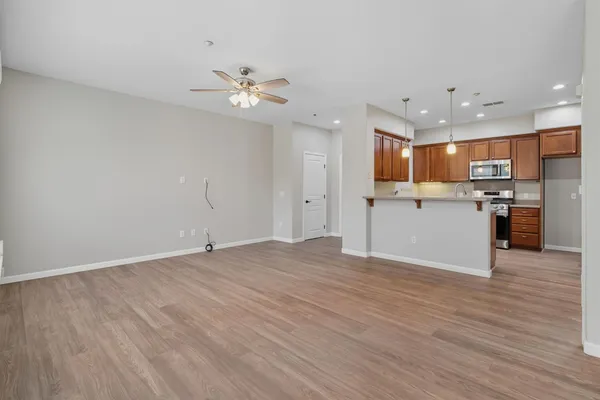 a view of a kitchen with a sink and a refrigerator