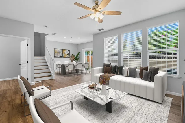 a living room with furniture couches and a large window