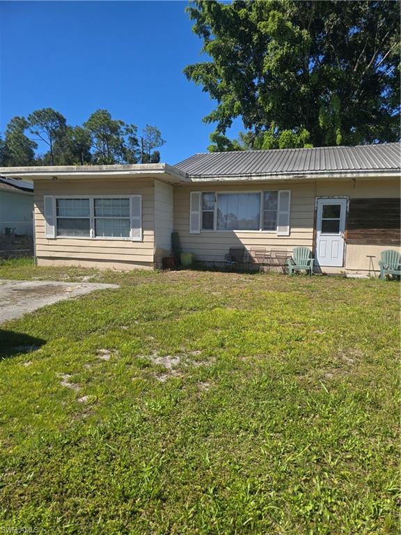 3023 Andrews Avenue Naples, FL 34112 - Photo 2 of 6 front view of a house with a yard