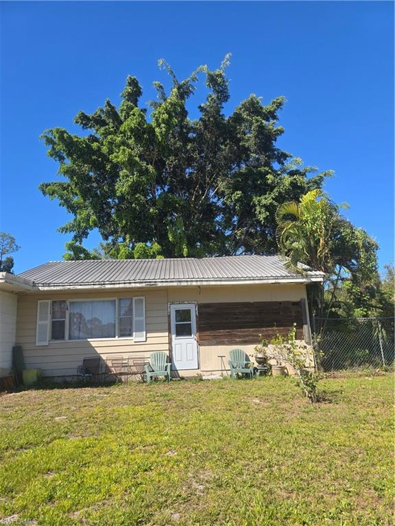 3023 Andrews Avenue Naples, FL 34112 - Photo 3 of 6 a front view of a house with garden