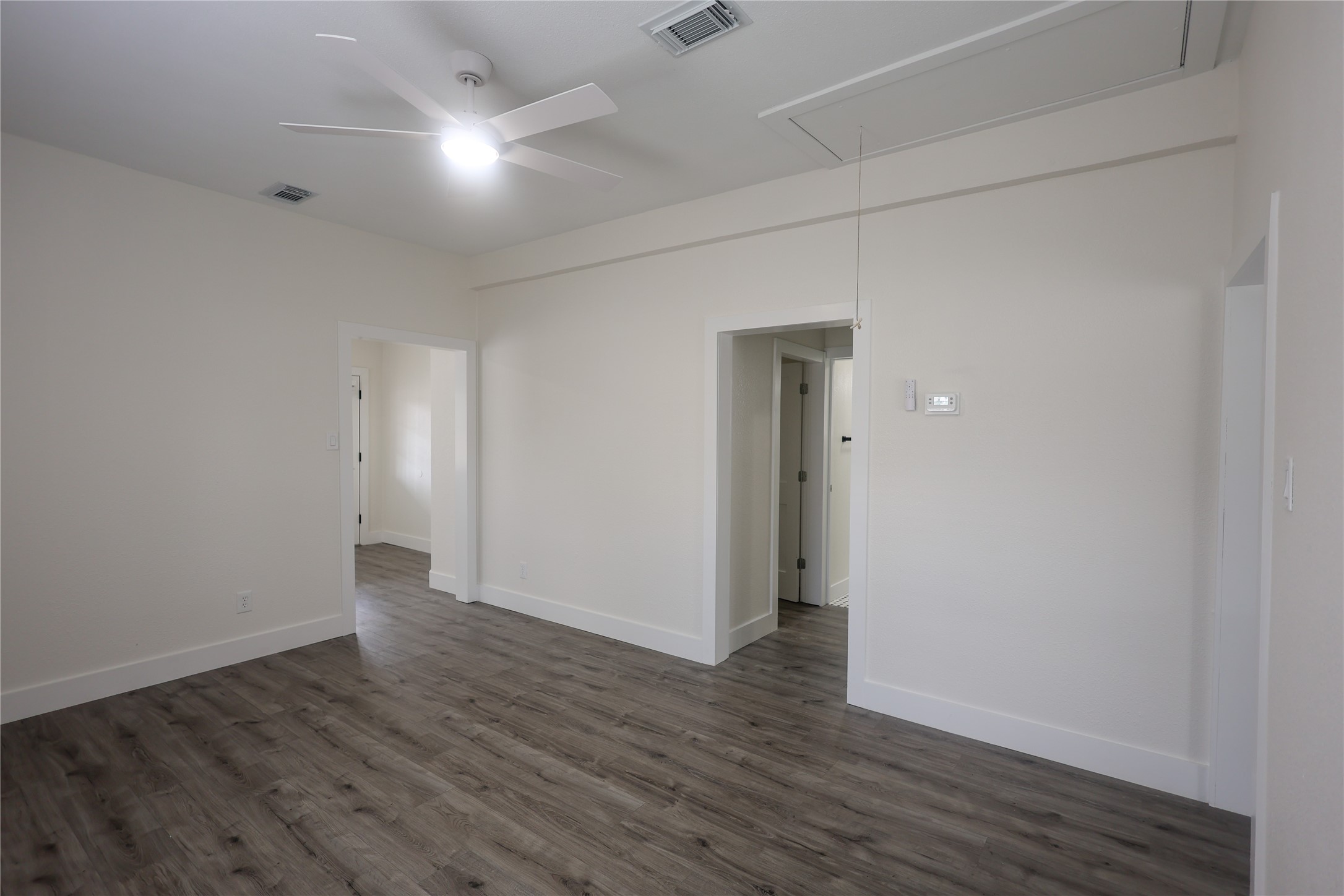 602 Higgins Street Humble, TX 77338 - Photo 10 of 39 a view of an empty room with wooden floor
