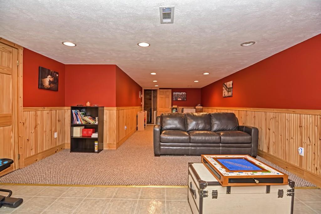 31 Oakland Road Pepperell, MA 01463 - Photo 17 of 20 a living room with furniture gym equipment and a chandelier