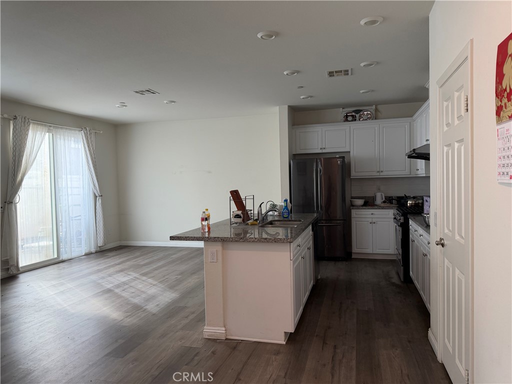 2066 Sentinel Privado Ontario, CA 91764 - Photo 3 of 10 a kitchen with a sink and refrigerator
