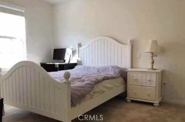 2066 Sentinel Privado Ontario, CA 91764 - Photo 6 of 10 a bedroom with a bed and a flat tv screen on dresser