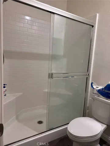 a white toilet sitting next to a bath tub