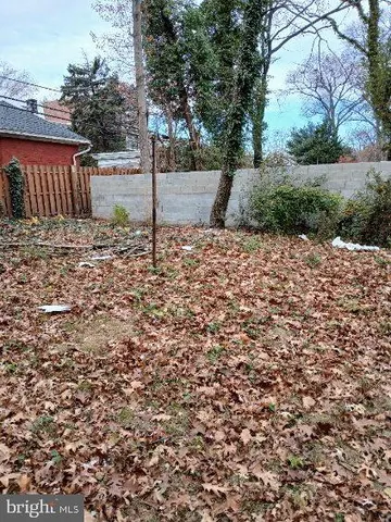 a view of a yard with iron fence