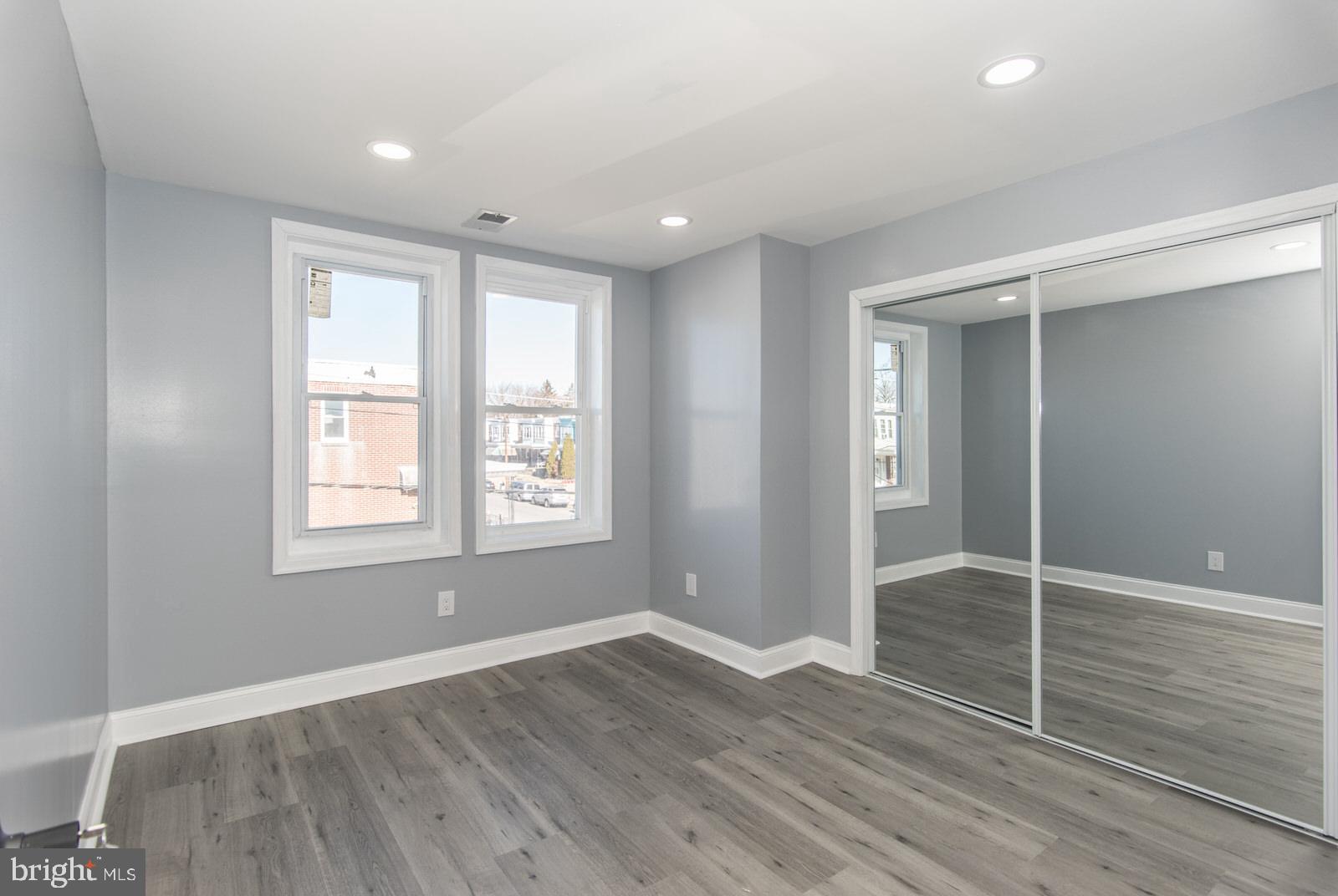 460 Robbins Street Philadelphia, PA 19111 - Photo 13 of 34 an empty room with wooden floor and windows