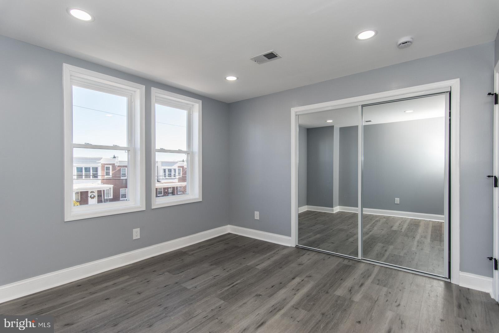 460 Robbins Street Philadelphia, PA 19111 - Photo 14 of 34 an empty room with wooden floor and windows
