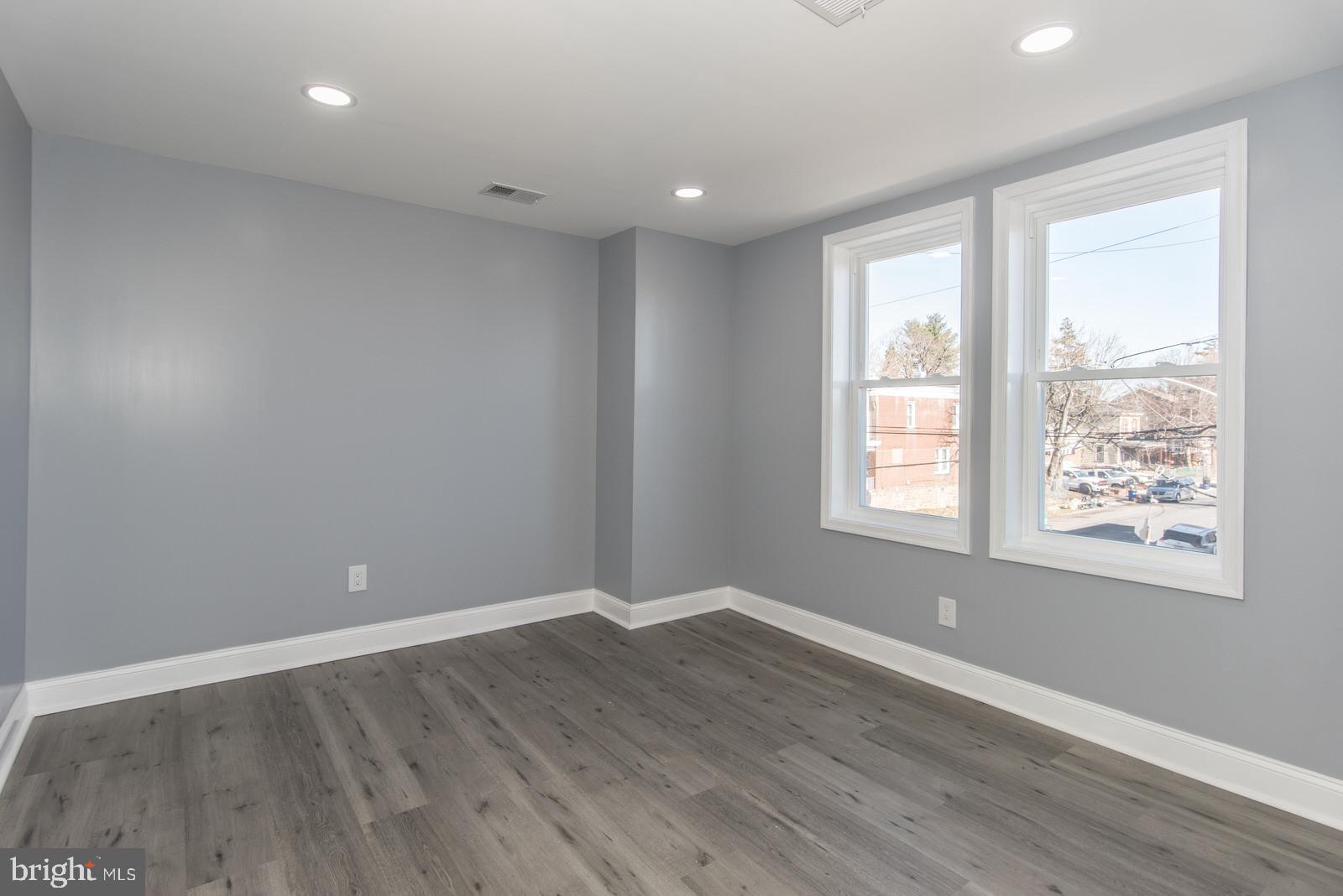 460 Robbins Street Philadelphia, PA 19111 - Photo 15 of 34 an empty room with wooden floor and windows