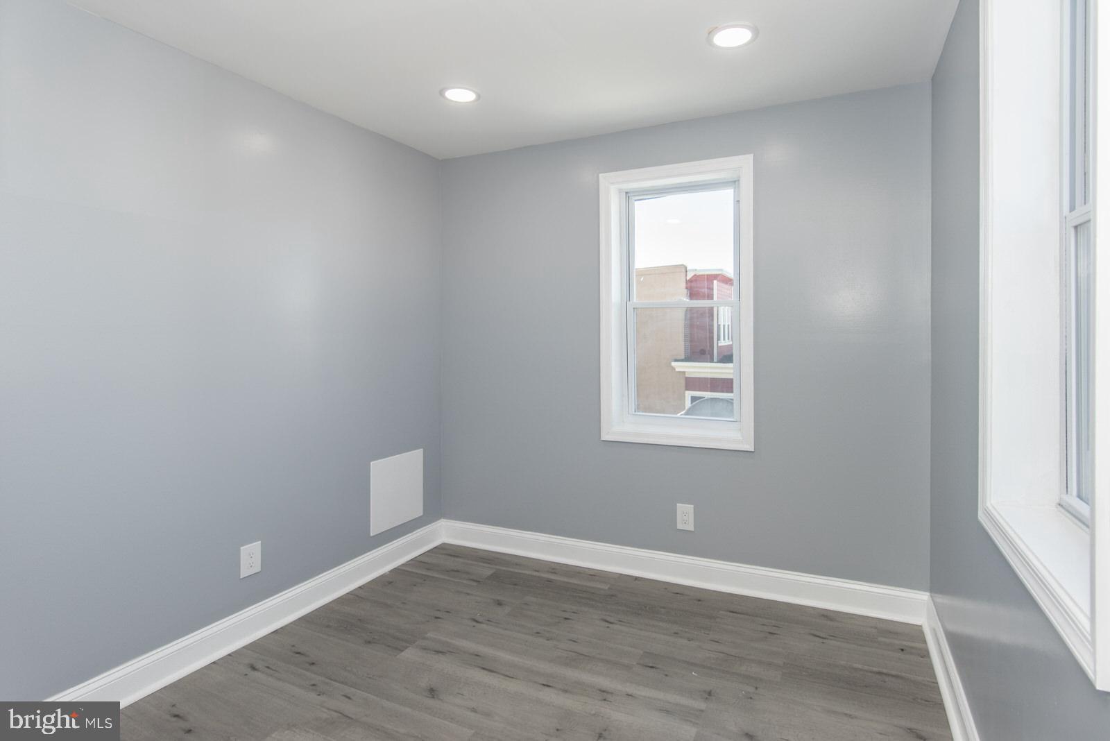 460 Robbins Street Philadelphia, PA 19111 - Photo 17 of 34 an empty room with wooden floor and windows