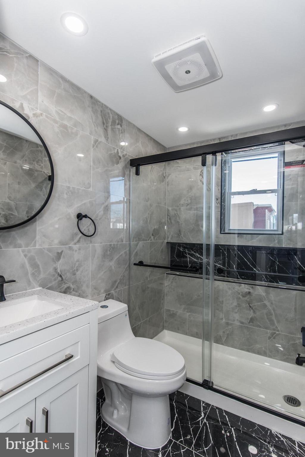 460 Robbins Street Philadelphia, PA 19111 - Photo 19 of 34 a bathroom with a toilet a sink and mirror