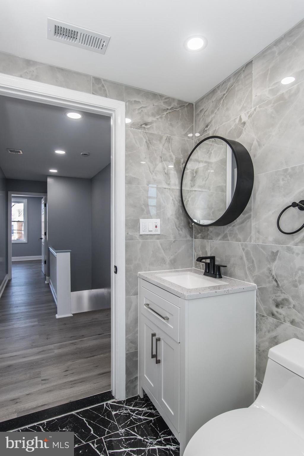 460 Robbins Street Philadelphia, PA 19111 - Photo 21 of 34 a bathroom with a toilet a sink and mirror