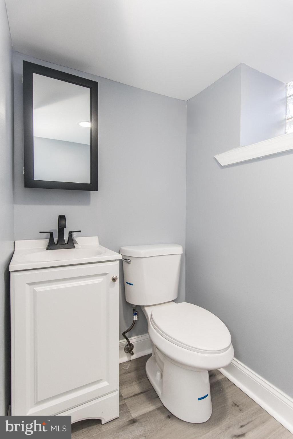 460 Robbins Street Philadelphia, PA 19111 - Photo 25 of 34 a bathroom with a toilet sink and mirror
