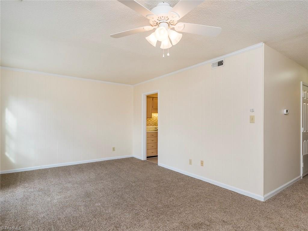 4832 Tower Road, Unit B Greensboro, NC 27410 - Photo 13 of 24 Access to the half bath on the main level and kitchen from living room.