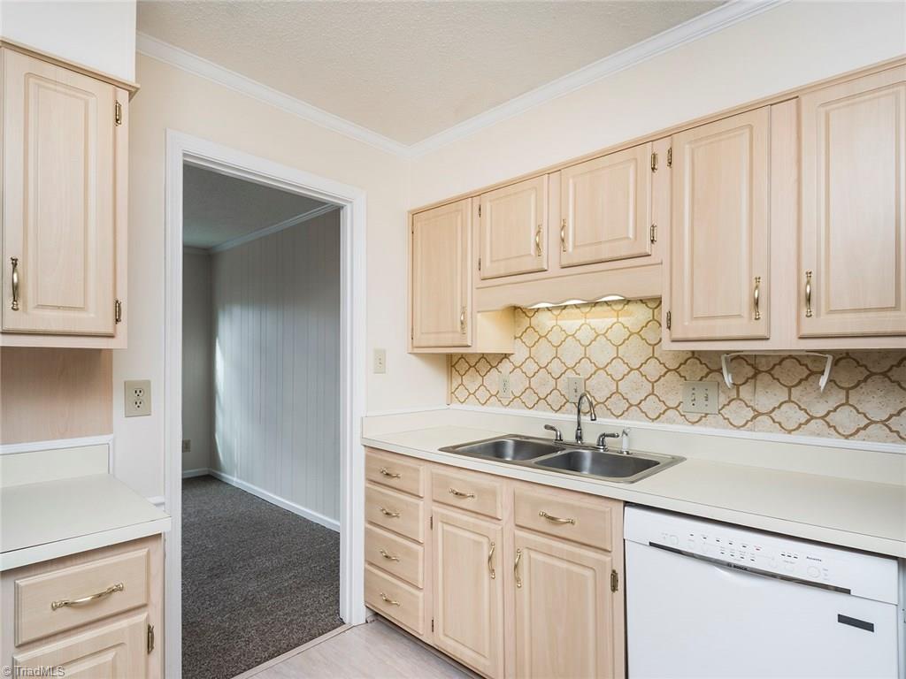 4832 Tower Road, Unit B Greensboro, NC 27410 - Photo 4 of 24 Kitchen offers great counter and cabinet space! directly off living room with access to formal dining room and has pantry.