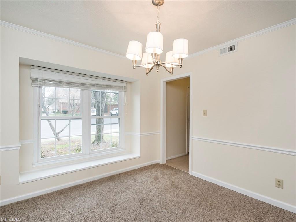 4832 Tower Road, Unit B Greensboro, NC 27410 - Photo 6 of 24 Dining room with beautiful bay window and chair railing.