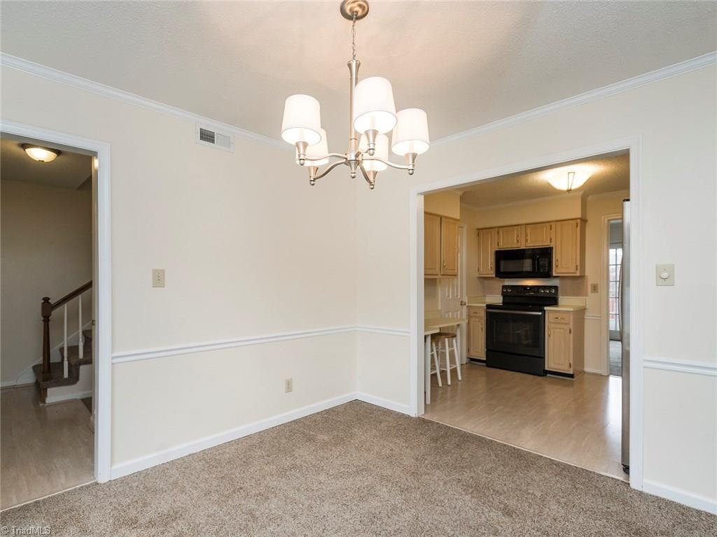 4832 Tower Road, Unit B Greensboro, NC 27410 - Photo 7 of 24 The dining room is open to the kitchen and main entry way of the home.