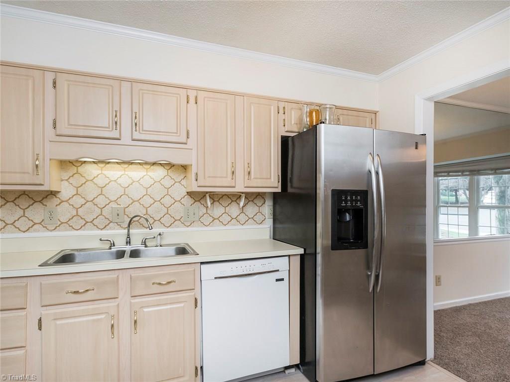 4832 Tower Road, Unit B Greensboro, NC 27410 - Photo 10 of 24 Kitchen is just off the dining room with access to the living room.