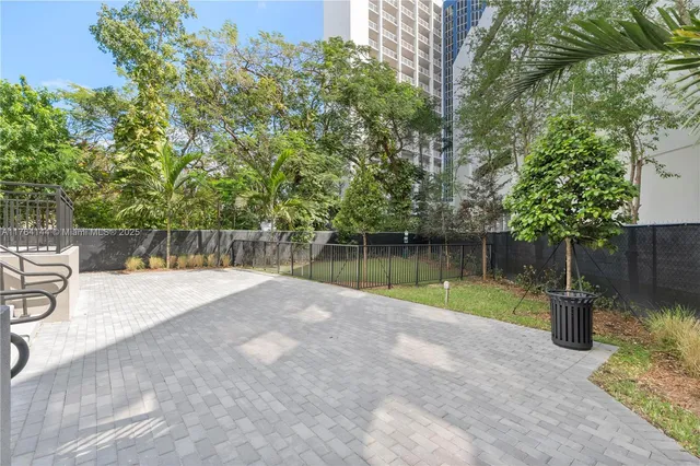 a backyard of a house with a yard and outdoor seating