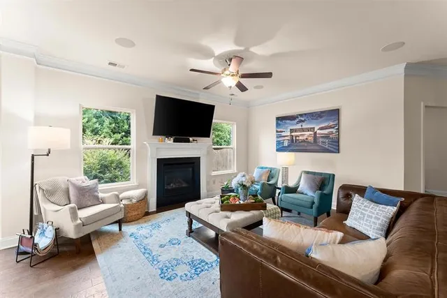 a living room with furniture a fireplace and a flat screen tv