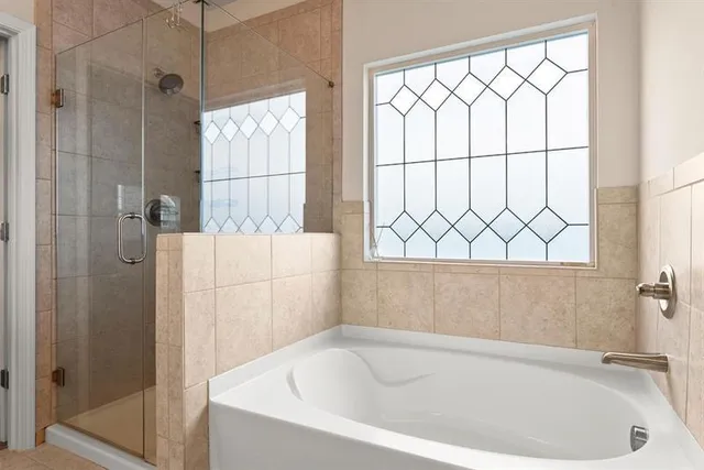 a white bath tub sitting next to a shower