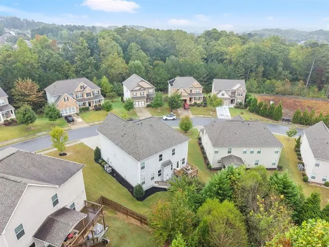 an aerial view of a house with garden space and street view