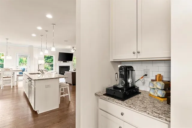 a kitchen with stainless steel appliances granite countertop a sink stove and cabinets