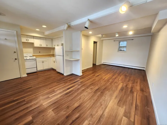 a view of kitchen with wooden floor and electronic appliances