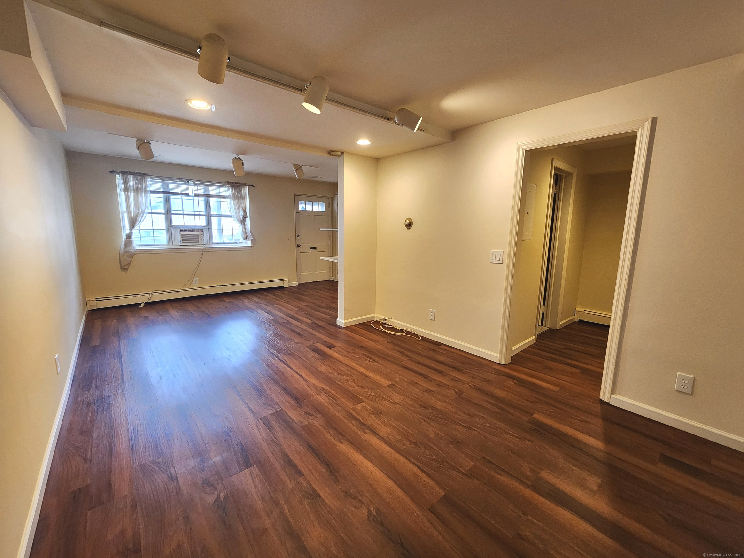 1856 Summer Street, Unit 1856 Stamford, CT 06905 - Photo 4 of 11 an empty room with wooden floor and windows