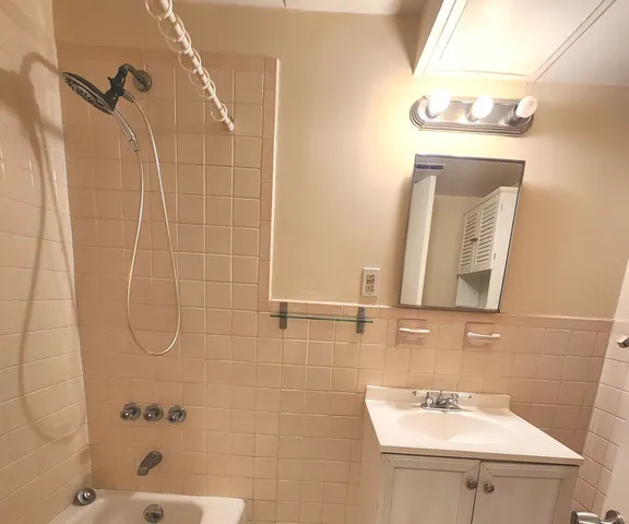 a bathroom with a sink a mirror and shower