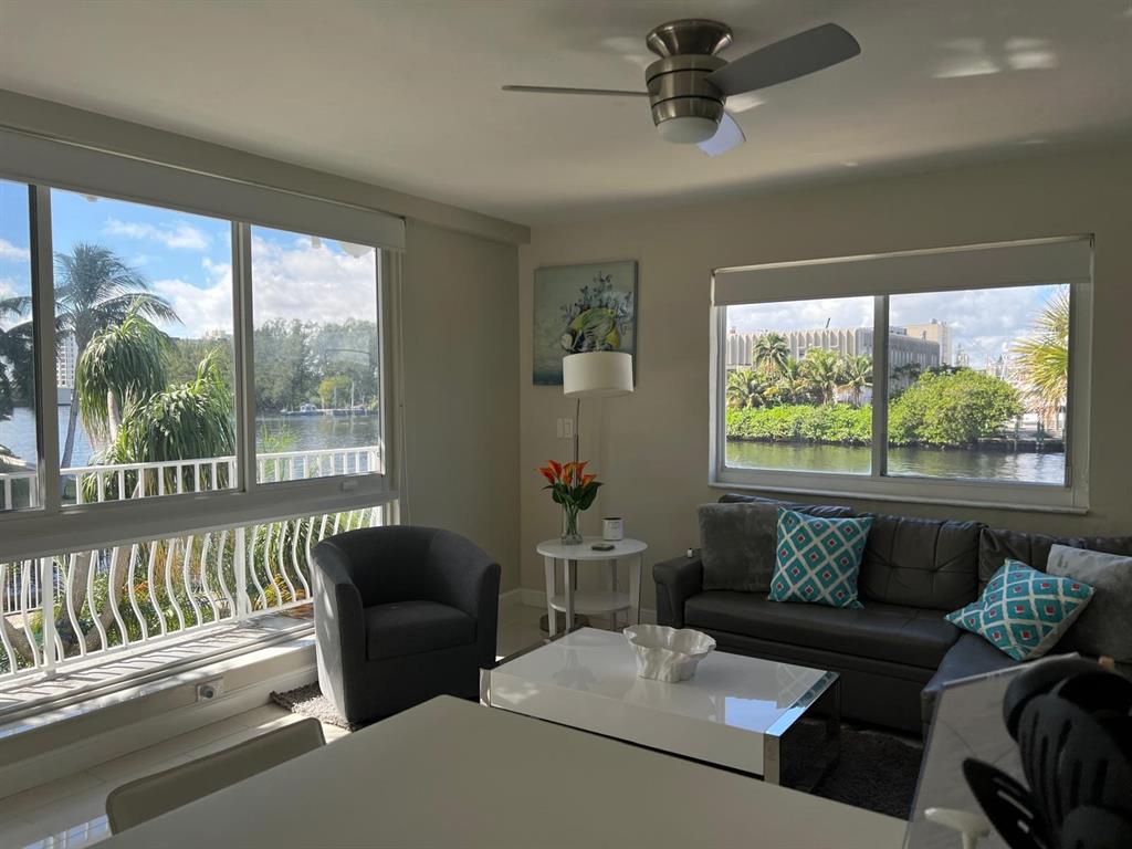 1705 North Riverside Drive, Unit 8 Pompano Beach, FL 33062 - Photo 12 of 40 a living room with furniture and a large window