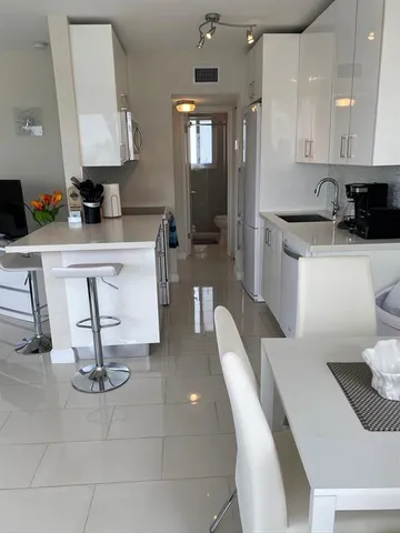 a kitchen with a sink a stove and refrigerator