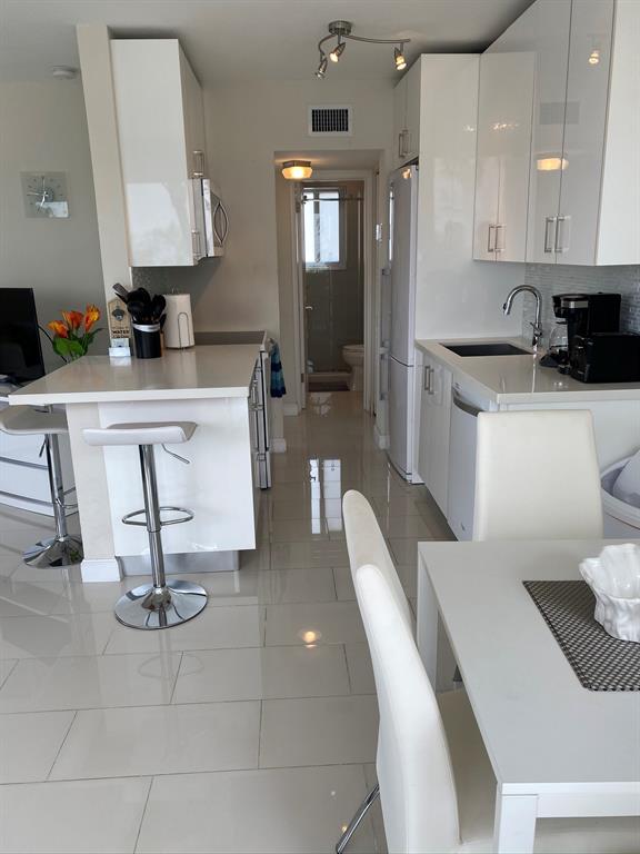 1705 North Riverside Drive, Unit 8 Pompano Beach, FL 33062 - Photo 16 of 40 a living room with furniture a rug and white walls