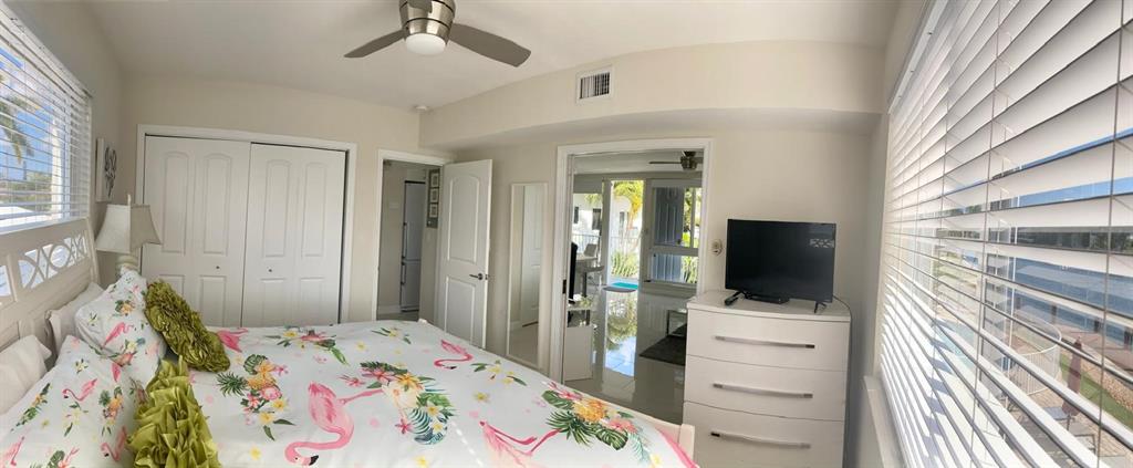 1705 North Riverside Drive, Unit 8 Pompano Beach, FL 33062 - Photo 19 of 40 a bed room with a bed and a flat tv screen