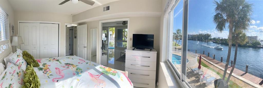 1705 North Riverside Drive, Unit 8 Pompano Beach, FL 33062 - Photo 20 of 40 a bedroom with a bed and a view of bathroom