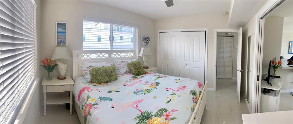 1705 North Riverside Drive, Unit 8 Pompano Beach, FL 33062 - Photo 21 of 40 a bedroom with a bed and a table in it