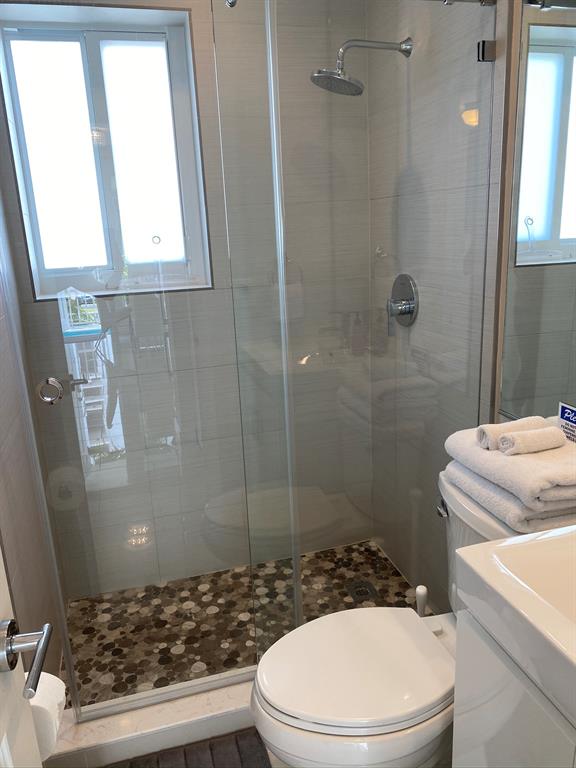 1705 North Riverside Drive, Unit 8 Pompano Beach, FL 33062 - Photo 23 of 40 a bathroom with a sink a toilet and shower