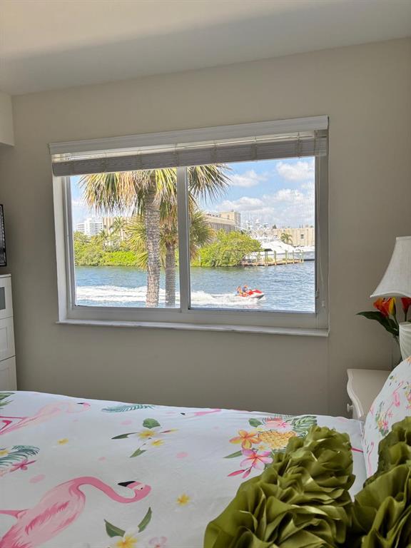 1705 North Riverside Drive, Unit 8 Pompano Beach, FL 33062 - Photo 39 of 40 a baby bed sitting in a bedroom next to a window