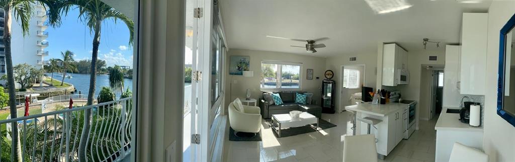 1705 North Riverside Drive, Unit 8 Pompano Beach, FL 33062 - Photo 9 of 40 a view of a balcony with furniture and floor to ceiling window
