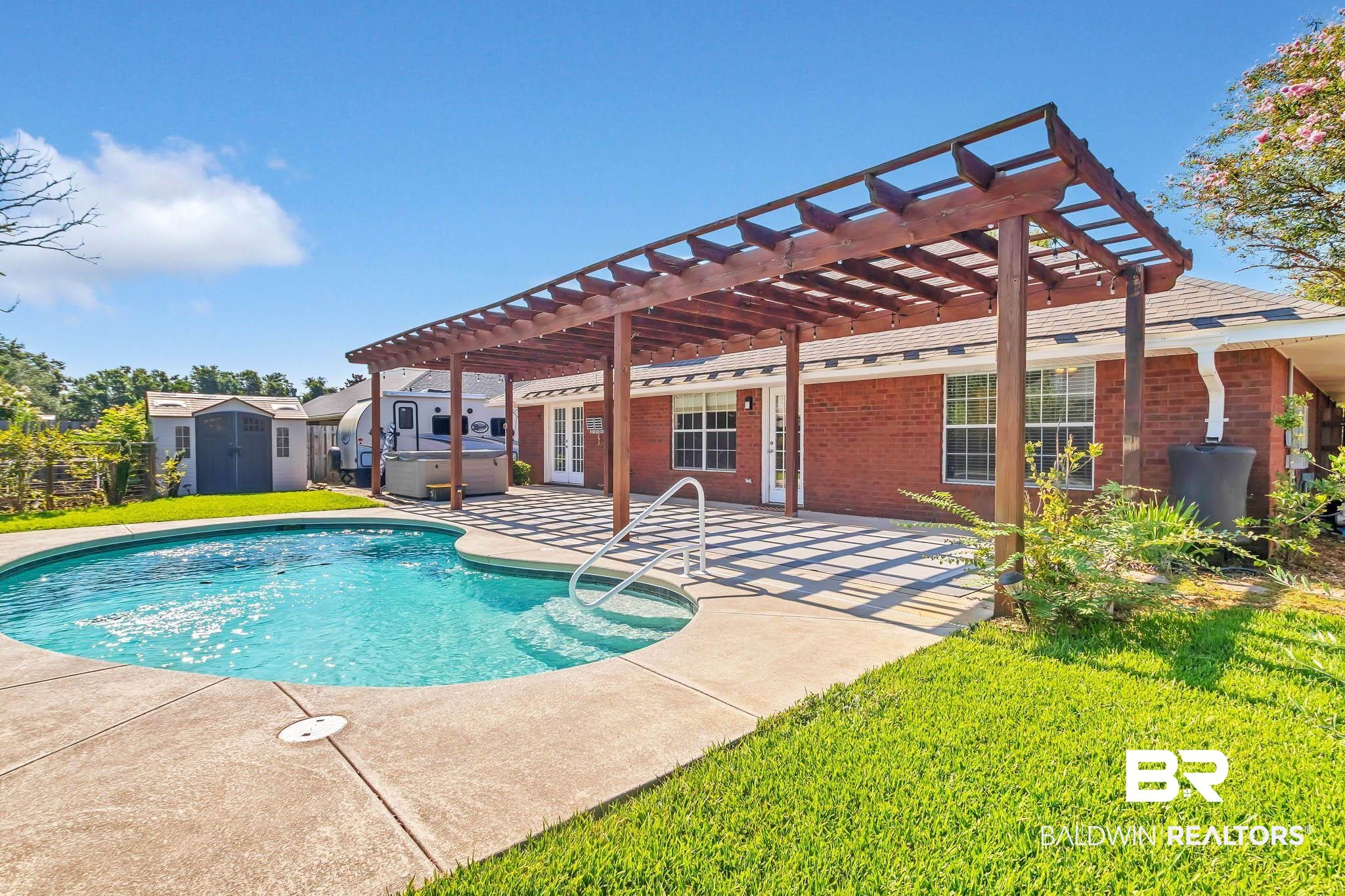 9607 Czar Court Fairhope, AL 36532 - Photo 35 of 42 Swimming pool featuring a pergola, a shed, a patio, a hot tub, and a yard