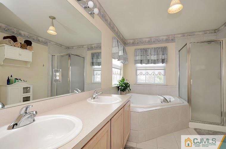 72 Timber Ridge Road North Brunswick, NJ 08902 - Photo 16 of 25 a bathroom with a tub sink and mirror