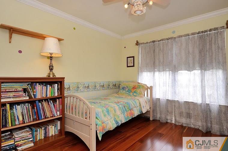 72 Timber Ridge Road North Brunswick, NJ 08902 - Photo 17 of 25 a bedroom with a bed a book shelf and a window