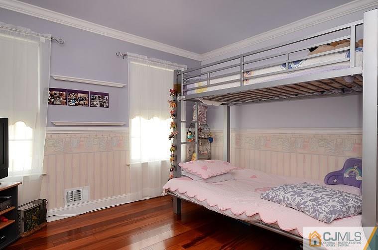 72 Timber Ridge Road North Brunswick, NJ 08902 - Photo 18 of 25 a bedroom with a bed and a flat screen tv