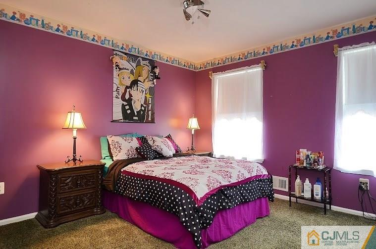 72 Timber Ridge Road North Brunswick, NJ 08902 - Photo 19 of 25 a bedroom with a bed and a lamp on table