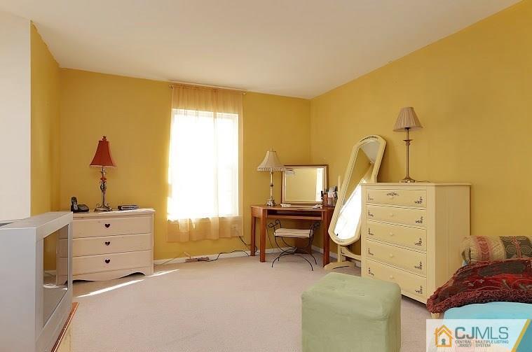 72 Timber Ridge Road North Brunswick, NJ 08902 - Photo 20 of 25 a bed room with a bed and furniture