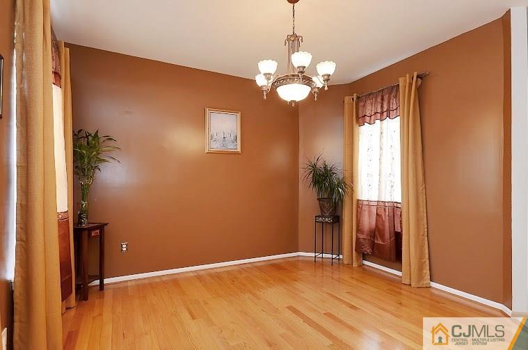 72 Timber Ridge Road North Brunswick, NJ 08902 - Photo 6 of 25 wooden floor in an empty room with a window