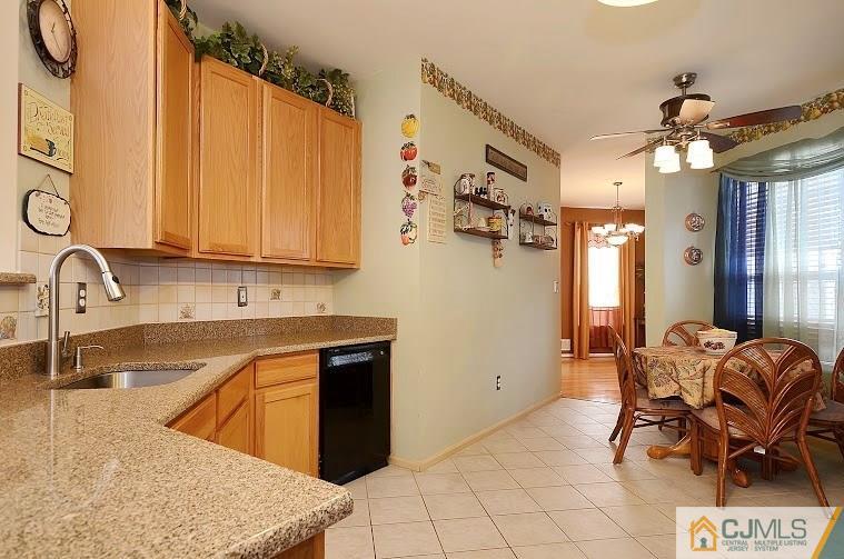 72 Timber Ridge Road North Brunswick, NJ 08902 - Photo 7 of 25 a kitchen with stainless steel appliances granite countertop a sink and a refrigerator