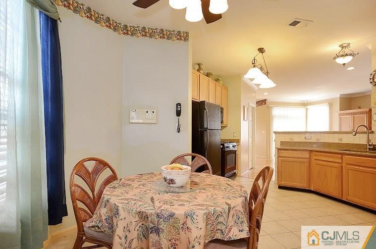 72 Timber Ridge Road North Brunswick, NJ 08902 - Photo 8 of 25 a view of a dining room with furniture and chandelier