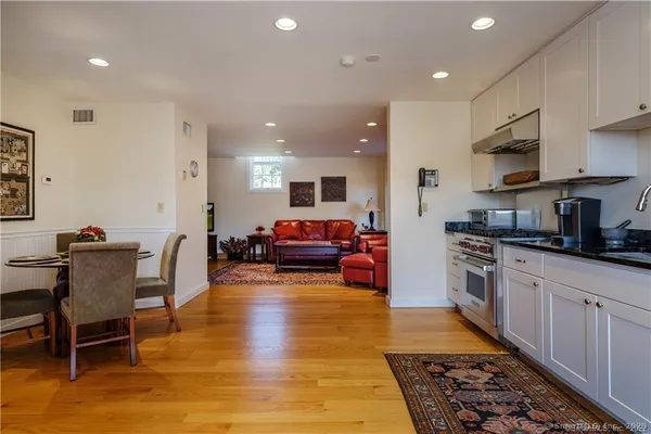 a kitchen with stainless steel appliances kitchen island granite countertop a sink and cabinets
